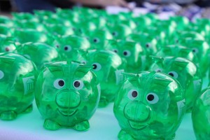 a dozen green plastic piggy banks